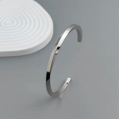 Metal lady's bracelet. Simple opening rotating rhombic stainless steel brooch. Jewelry for the wife's wedding party.